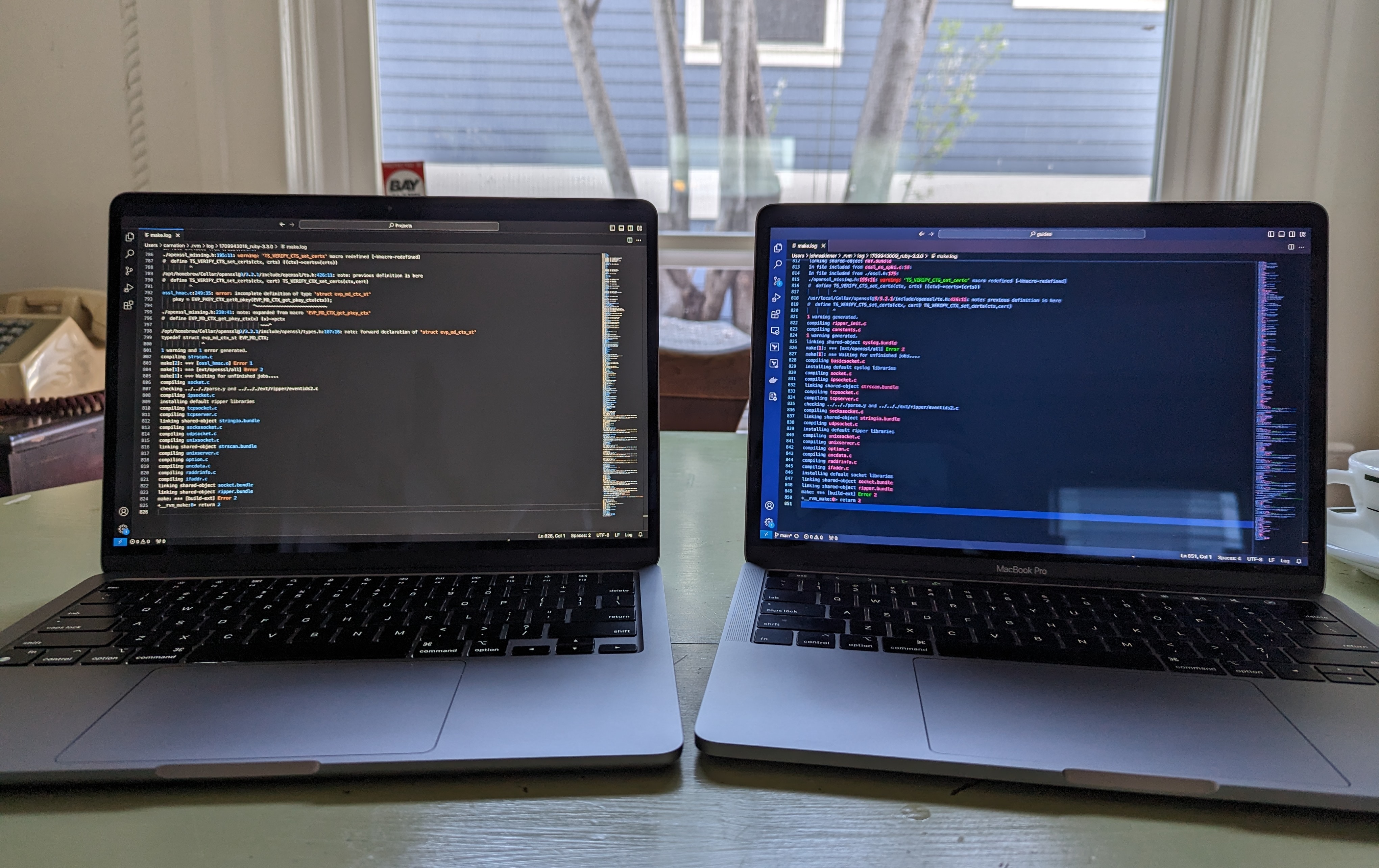 Two laptops showing visibly different log files